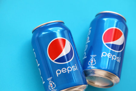 TERNOPIL, UKRAINE - MAY 28, 2022: Cold Pepsi drink cans. Pepsi is a carbonated soft drink produced...