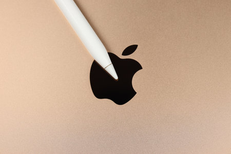 KHARKIV, UKRAINE - JANUARY 27, 2021: Apple Pencil on Brand new Apple iPad golden body surface with...