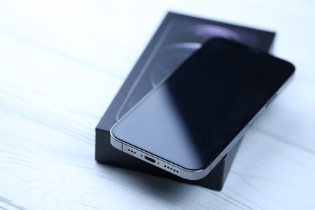 KHARKIV, UKRAINE - JANUARY 27, 2021: Apple Iphone 12 pro new brand model smartphone with IOS base on white background. Apple Inc. is an American technology company headquartered in Californiaのeditorial素材