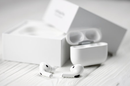 KHARKIV, UKRAINE - JANUARY 27, 2021: Apple AirPods Pro on a white background. Wireless headphones with charging case and a box. Apple Inc. is an American technology company headquartered in Californiaのeditorial素材