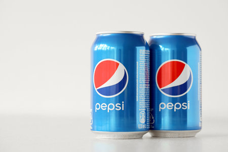 TERNOPIL, UKRAINE - MAY 28, 2022: Cold Pepsi drink cans om white background. Pepsi is a carbonated soft drink produced by PepsiCo since 1893のeditorial素材