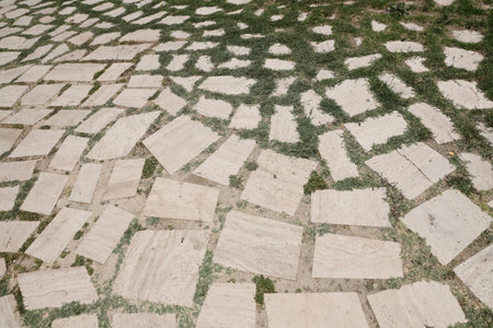 Wall background with yellow natural sandstone tiles stitched together with clayの写真素材