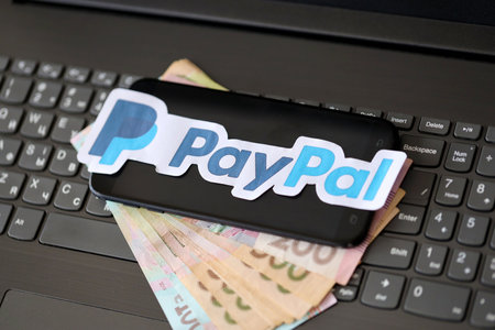 TERNOPIL, UKRAINE - SEPTEMBER 6, 2022 Paypal paper logotype lies on black laptop keyboard with...