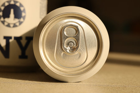 TERNOPIL, UKRAINE - JULY 18, 2022 Two cans of New Yorker fine lager beer with original and design on brown retro background surfaceのeditorial素材