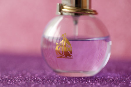 TERNOPIL, UKRAINE - SEPTEMBER 2, 2022 Lanvin Eclat Darpege perfume bottle on shiny glitter background in pink and purple colorsのeditorial素材