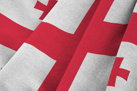 Georgia flag with big folds waving close up under the studio light indoors. The official symbols and colors in fabric bannerの写真素材