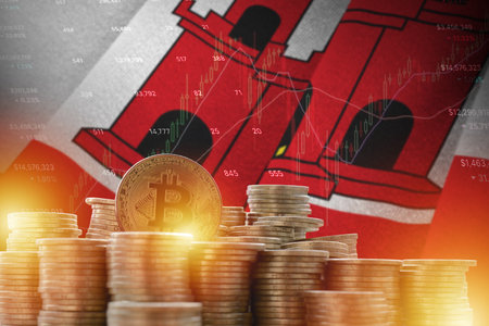 Giblartar flag and big amount of golden bitcoin coins and trading platform chart. Cryptocurrency conceptの写真素材