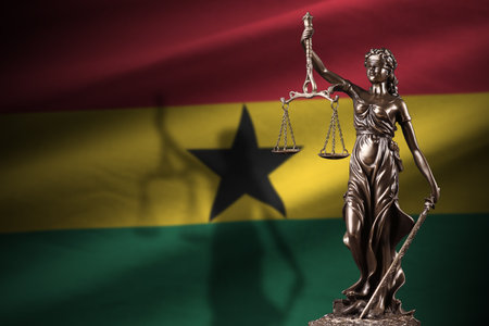 Ghana flag with statue of lady justice and judicial scales in dark room. Concept of judgment and punishment, background for jury topicsの写真素材
