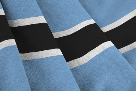 Botswana flag with big folds waving close up under the studio light indoors. The official symbols and colors in fabric bannerの写真素材