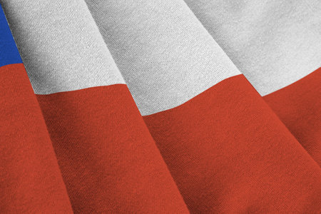 Chile flag with big folds waving close up under the studio light indoors. The official symbols and colors in fabric bannerの写真素材