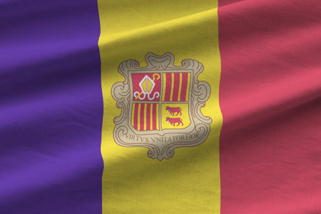 Andorra flag with big folds waving close up under the studio light indoors. The official symbols and colors in fabric bannerの写真素材