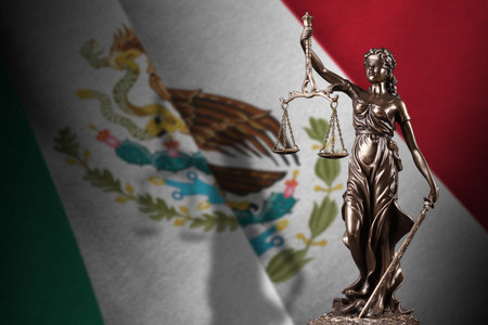 Mexico flag with statue of lady justice and judicial scales in dark room. Concept of judgment and punishment, background for jury topicsの写真素材