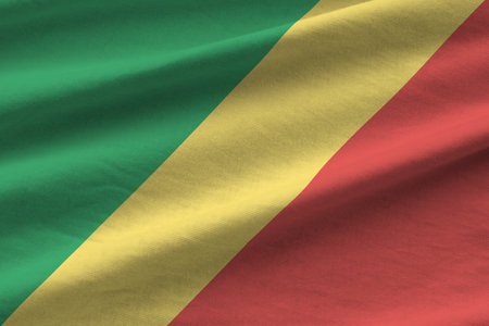 Congo flag with big folds waving close up under the studio light indoors. The official symbols and colors in fabric bannerの写真素材