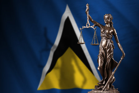 Saint Lucia flag with statue of lady justice and judicial scales in dark room. Concept of judgment and punishment, background for jury topicsの写真素材