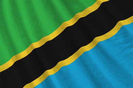 Tanzania flag with big folds waving close up under the studio light indoors. The official symbols and colors in fabric bannerの写真素材
