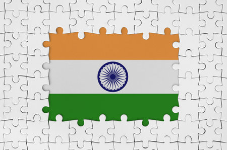 India flag in frame of white puzzle pieces with missing central partsの写真素材