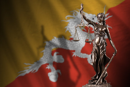Bhutan flag with statue of lady justice and judicial scales in dark room. Concept of judgement and punishment, background for jury topicsの写真素材