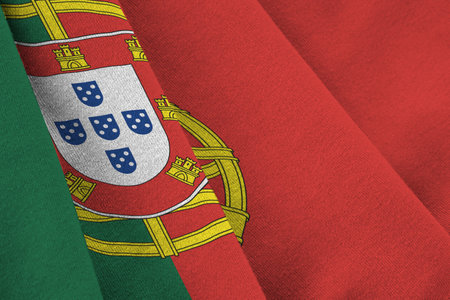Portugal flag with big folds waving close up under the studio light indoors. The official symbols and colors in fabric bannerの写真素材