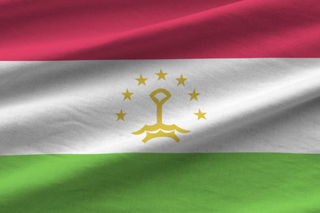 Tajikistan flag with big folds waving close up under the studio light indoors. The official symbols and colors in fabric bannerの写真素材