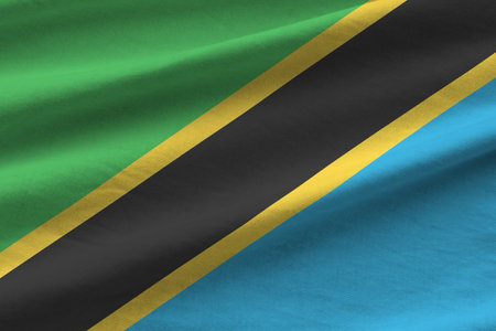 Tanzania flag with big folds waving close up under the studio light indoors. The official symbols and colors in fabric bannerの写真素材