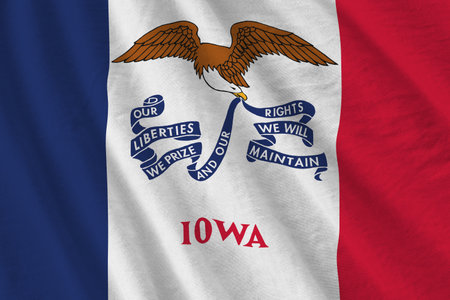Iowa US state flag with big folds waving close up under the studio light indoors. The official symbols and colors in fabric bannerの写真素材