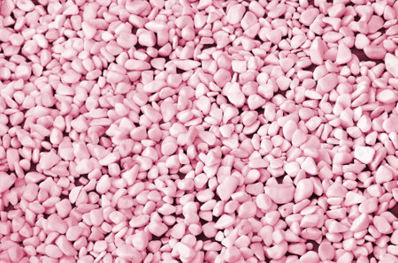 A lot of round and oval stones of white color lie on the ground in the garden Image toned in Viva...