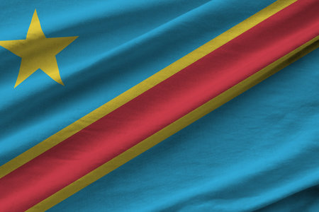Democratic Republic of the Congo flag with big folds waving close up under the studio light indoors. The official symbols and colors in fabric bannerの写真素材