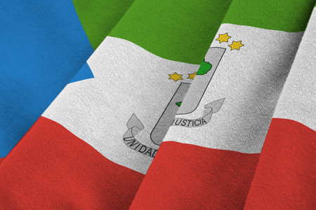 Equatorial Guinea flag with big folds waving close up under the studio light indoors. The official symbols and colors in fabric bannerの写真素材