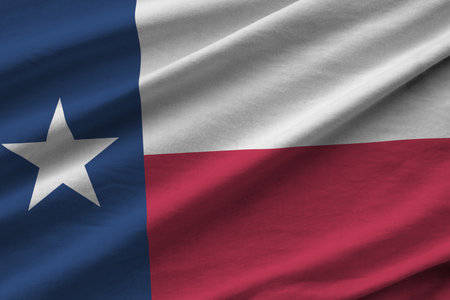 Texas US state flag with big folds waving close up under the studio light indoors. The official symbols and colors in fabric bannerの写真素材