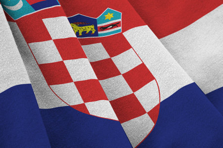 Croatia flag with big folds waving close up under the studio light indoors. The official symbols and colors in fabric bannerの写真素材