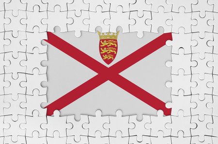 Jersey flag in frame of white puzzle pieces with missing central partsの写真素材
