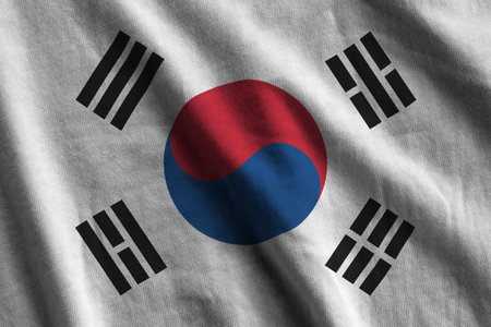 South Korea flag with big folds waving close up under the studio light indoors. The official symbols...