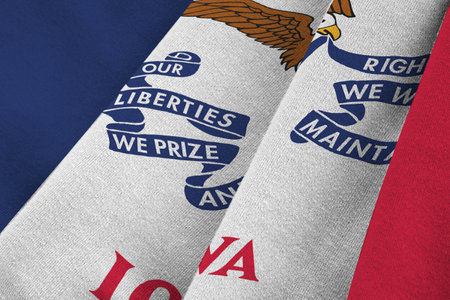 Iowa US state flag with big folds waving close up under the studio light indoors. The official symbols and colors in fabric bannerの写真素材