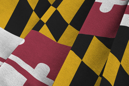 Maryland US state flag with big folds waving close up under the studio light indoors. The official symbols and colors in fabric bannerの写真素材