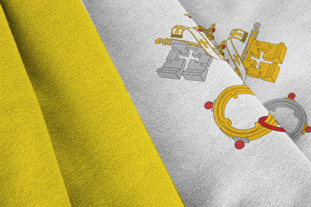 Vatican City State flag with big folds waving close up under the studio light indoors. The official symbols and colors in fabric bannerの写真素材