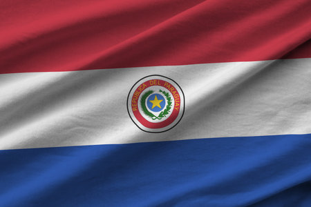 Paraguay flag with big folds waving close up under the studio light indoors. The official symbols and colors in fabric bannerの写真素材
