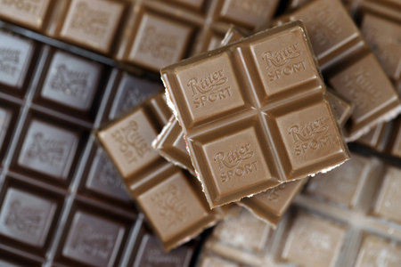 KYIV, UKRAINE - MAY 4, 2022 Ritter Sport chocolate bars with various tastes without wrappings. Many chocolate tiles with different flavours close up with Ritter Sport logoのeditorial素材