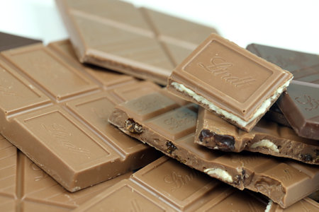 KYIV, UKRAINE - MAY 4, 2022 Lindt Swiss luxury brand chocolate brown tablets with embossed original company logo.のeditorial素材