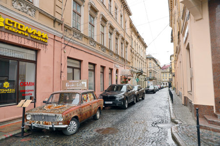 LVIV, UKRAINE - SEPTEMBER 11, 2022 Street view of the historical old city in Lviv, Ukraine. Many old buildings and facade ornaments in tight european style streets of Lvivのeditorial素材