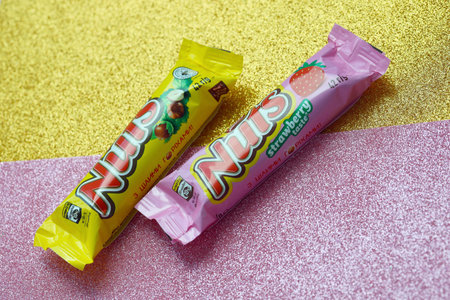 KYIV, UKRAINE - MAY 4, 2022 Nuts original chocolate bar manufactured by Nestle company. Small chocolate with nuts and nougat in colorful wrappingのeditorial素材