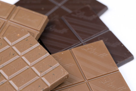 KYIV, UKRAINE - MAY 4, 2022 Lindt Swiss luxury brand chocolate brown tablets with embossed original company logo.のeditorial素材