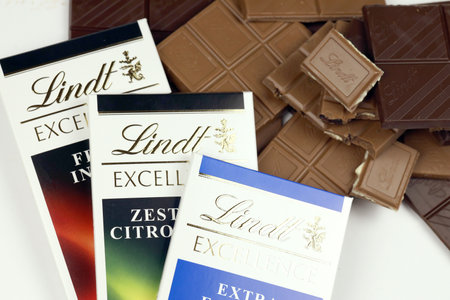 KYIV, UKRAINE - MAY 4, 2022 Lindt Swiss luxury brand chocolate brown tablets with embossed original company logo.のeditorial素材