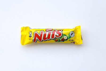 KYIV, UKRAINE - MAY 4, 2022 Nuts original chocolate bar manufactured by Nestle company. Small chocolate with nuts and nougat in colorful wrappingのeditorial素材