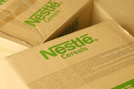 KYIV, UKRAINE - MAY 4, 2022 Big cardboard boxes with logo of Nestle company. Porduction storage of nestle goodsのeditorial素材