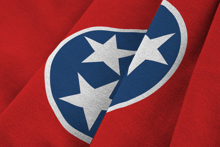 Tennessee US state flag with big folds waving close up under the studio light indoors. The official symbols and colors in fabric bannerの写真素材