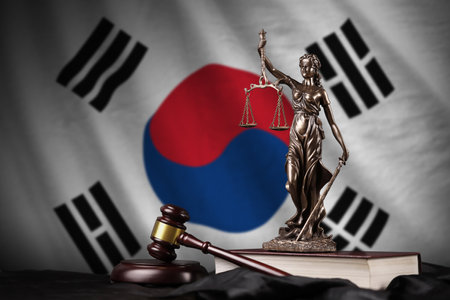 South Korea flag with statue of lady justice, constitution and judge hammer on black drapery. Concept of judgement and punishmentの写真素材