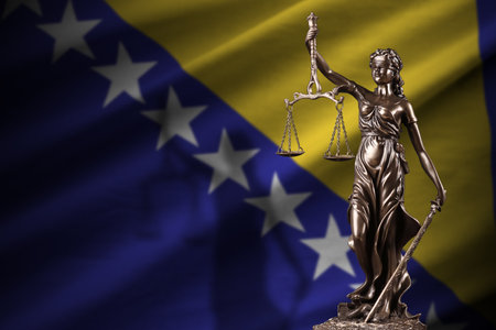 Bosnia and Herzegovina flag with statue of lady justice and judicial scales in dark room. Concept of judgement and punishment, background for jury topicsの写真素材