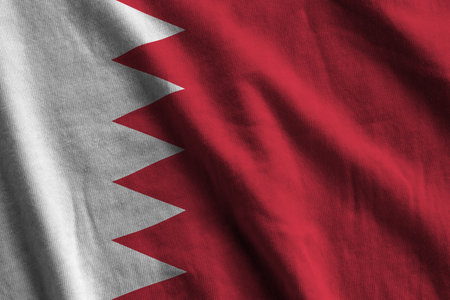 Bahrain flag with big folds waving close up under the studio light indoors. The official symbols and colors in fabric bannerの写真素材