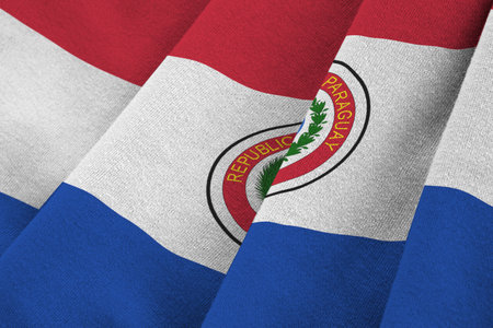 Paraguay flag with big folds waving close up under the studio light indoors. The official symbols...