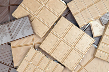 KYIV, UKRAINE - MAY 4, 2022 Lindt Swiss luxury brand chocolate brown tablets with embossed original company logo.のeditorial素材